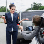 business people screaming on road after car accident