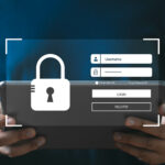 Person holding tablet with cybersecurity login interface